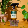 Bottle of Plant Runner Neem Oil with plants in the background